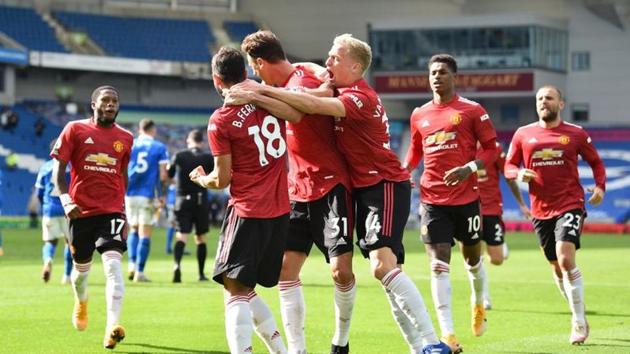 Manchester United's Bruno Fernandes celebrates scoring their third goal with teammates.(Pool via REUTERS)
