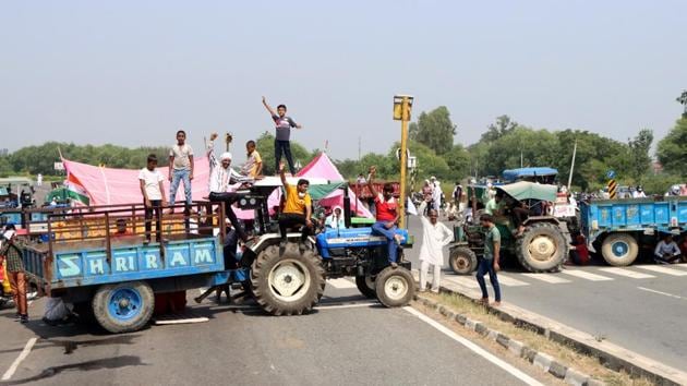 Farmers block the road in protest against the passing of agriculture reform bills in the Parliament, at Rohtak-Chandigarh National Highway, near Brahaman Bass village, in Rohtak, Haryana.(Manoj Dhaka/Hindustan Times) Farmers block the road in protest against the passing of agriculture reform bills in the Parliament, at Rohtak-Chandigarh National Highway, near Brahaman Bass village, in Rohtak, Haryana.(Manoj Dhaka/Hindustan Times)