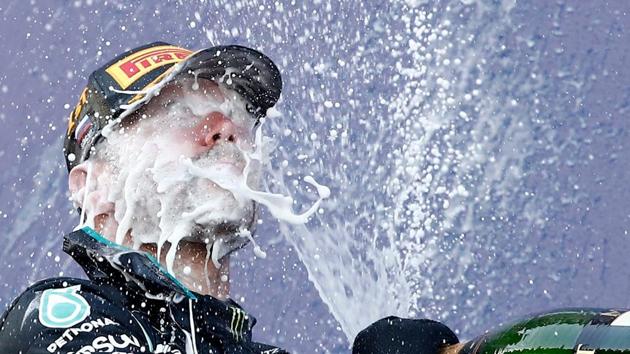 Formula One F1 - Russian Grand Prix - Sochi Autodrom, Sochi, Russia - September 27, 2020. Mercedes' Valtteri Bottas celebrates with sparkling wine on the podium after winning the race. Pool via REUTERS/Maxim Shemetov TPX IMAGES OF THE DAY(Pool via REUTERS)