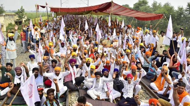 Farmers continue to sit on a ‘Rail Roko’ protest against the new agriculture laws at Amritsar-Delhi rail link in village Devi Dass Pura in Amritsar on September 28. Two of the three reform bills were passed controversially in Rajya Sabha where opposition members in the house alleged the bills were passed “unconstitutionally.” Opposition as well as farmers’ protests have gained momentum since then, even as the reforms are set to be implemented. (Sameer Sehgal / HT Photo) Farmers continue to sit on a ‘Rail Roko’ protest against the new agriculture laws at Amritsar-Delhi rail link in village Devi Dass Pura in Amritsar on September 28. Two of the three reform bills were passed controversially in Rajya Sabha where opposition members in the house alleged the bills were passed “unconstitutionally.” Opposition as well as farmers’ protests have gained momentum since then, even as the reforms are set to be implemented. (Sameer Sehgal / HT Photo)