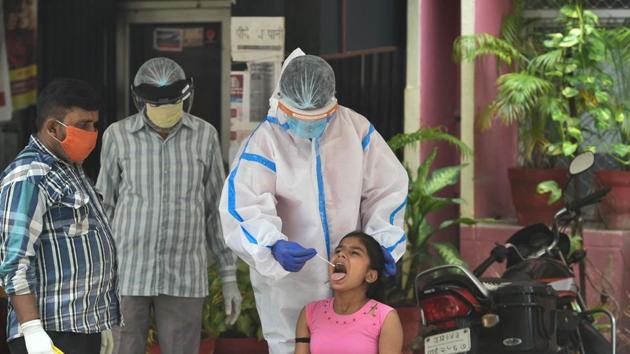 Lucknow: A medic collects a swab sample from a girl for COVID-19 test, during the weekend lockdown in the wake of coronavirus pandemic, in Lucknow, Saturday, Aug 8, 2020. (PTI Photo/Nand Kumar)(PTI08-08-2020_000090A)(PTI)