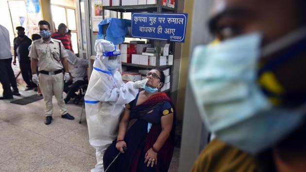 A health worker in PPE coveralls collects a swab sample from a person for coronavirus testing, at a government dispensary in New Delhi on September 28, 2020.(Raj K Raj/HT Photo) A health worker in PPE coveralls collects a swab sample from a person for coronavirus testing, at a government dispensary in New Delhi on September 28, 2020.(Raj K Raj/HT Photo)