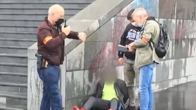 This grab taken from a video obtained by AFP shows French police detaining an alleged suspect after several people were injured near the former offices of the French satirical magazine Charlie Hebdo following an attack by a man wielding a knife in Paris on September 25, 2020.(AFP)