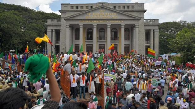 Protesters from various farmers’ rights organizations stage an anti-government demonstration in Bangalore on September 28. The All India Kisan Sabha and other organisations protested in front of Hemavathi statue while some held a bike rally. Some farmers’ organizations on the other hand offered flowers to shopkeepers in Hubli and requested them to support the statewide bandh, HT reported. (Manjunath Kiran / AFP) Protesters from various farmers’ rights organizations stage an anti-government demonstration in Bangalore on September 28. The All India Kisan Sabha and other organisations protested in front of Hemavathi statue while some held a bike rally. Some farmers’ organizations on the other hand offered flowers to shopkeepers in Hubli and requested them to support the statewide bandh, HT reported. (Manjunath Kiran / AFP)
