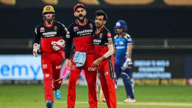 Royal Challengers Bangalore players Yuzvendra Chahal, Virat Kohli and others celebrate the wicket of Mumbai Indians batsman Quinton de Kock. (PTI) Royal Challengers Bangalore players Yuzvendra Chahal, Virat Kohli and others celebrate the wicket of Mumbai Indians batsman Quinton de Kock. (PTI)