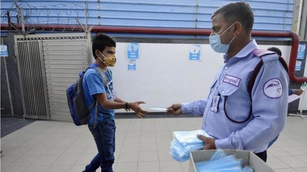 An aspirant collects a face mask as he arrives at a test centre to appear for the JEE Advanced exam in Noida on September 27. The latest million infections were recorded in just 11 days. The number of deaths from the disease meanwhile approaches 100,000, and the number of those who have so far recovered has surpassed five million. (Sunil Ghosh / HT Photo) An aspirant collects a face mask as he arrives at a test centre to appear for the JEE Advanced exam in Noida on September 27. The latest million infections were recorded in just 11 days. The number of deaths from the disease meanwhile approaches 100,000, and the number of those who have so far recovered has surpassed five million. (Sunil Ghosh / HT Photo)