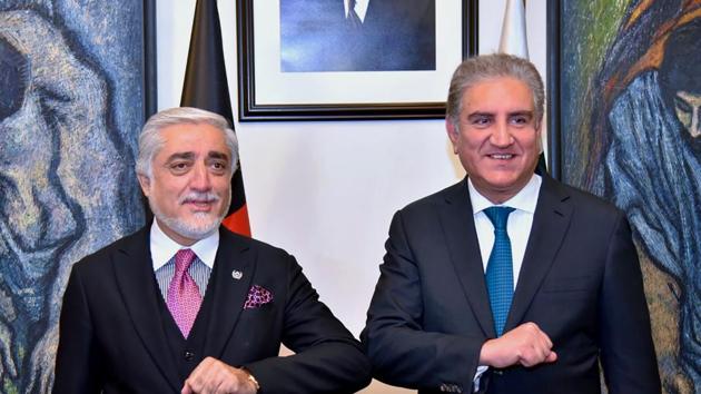 Abdullah Abdullah (left) chairman of Afghanistan's High Council for National Reconciliation, bumps elbows with Pakistani foreign minister Shah Mahmood Qureshi, during a meeting in Islamabad.(AP)
