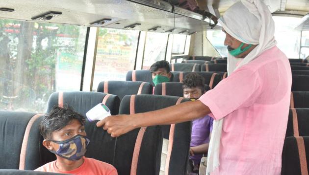 File photo: Bus conductor measuring temperature of passengers.(FChandan Paul- Hindustan Times)