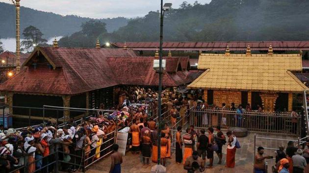 Devotees wait in queues inside the premises of the Sabarimala temple in Pathanamthitta district of Kerala.(Reuters file photo)