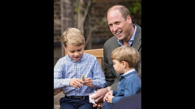 Prince George holds the tooth of a giant shark given to him by David Attenborough.(Reuters) Prince George holds the tooth of a giant shark given to him by David Attenborough.(Reuters)