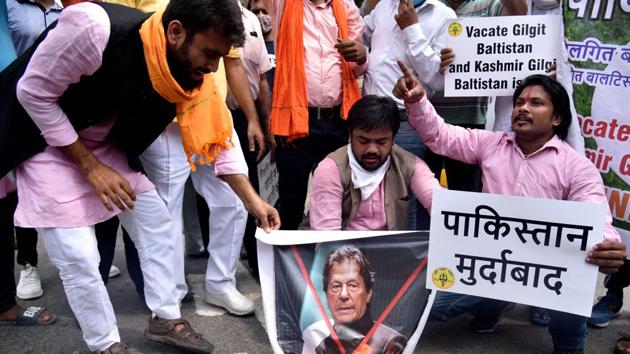 Member of Hindu Sena burn a poster of Pakistan PM Imran Khan during a protest against illegal annexure of Gilgit Baltistan into Pakistan, near teen murti in New Delhi on Wednesday.(ANI) Member of Hindu Sena burn a poster of Pakistan PM Imran Khan during a protest against illegal annexure of Gilgit Baltistan into Pakistan, near teen murti in New Delhi on Wednesday.(ANI)