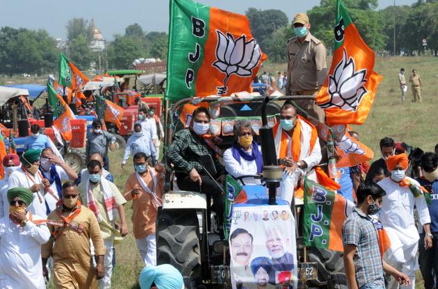 MP and BJP Kisan Morcha president Raj Kumar Chahar with senior party leaders from the city and workers taking out a tractor rally.(Keshav Singh/HT Photo)