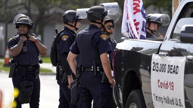 Cleveland Police officers surround a vehicle outside the Health Education Campus of Case Western Reserve University in Cleveland on September 28. According to ANI, the venue is already heavily guarded by local and federal law enforcement agencies, including a National Guard task force to minimize all possible distractions. (Julio Cortez / AP)