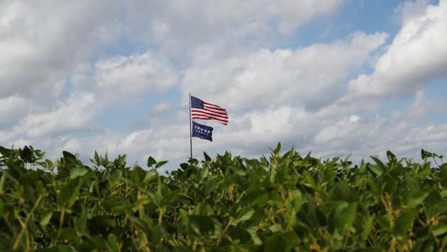 A US flag flutters above a flag supporting US President Donald Trump and Vice President Mike Pence in Jackson, Ohio on September 28. (Shannon Stapleton / REUTERS)