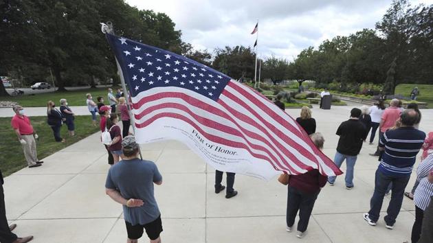 Veteran and Luzerne County employee Dino Ninotti holds a Flag of Honor during a 911 Ceremony Friday.(AP) Veteran and Luzerne County employee Dino Ninotti holds a Flag of Honor during a 911 Ceremony Friday.(AP)