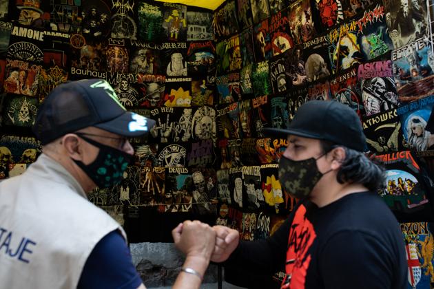 A vendor greets a customer at the El Chopo punk rock market in Mexico City, Mexico.(Bloomberg) A vendor greets a customer at the El Chopo punk rock market in Mexico City, Mexico.(Bloomberg)