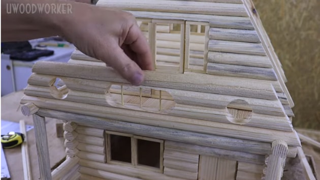 The image shows the model house in progress.(YouTube/@UWOODWORKER)