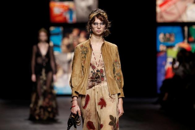 Models presented creations by designer Maria Grazia Chiuri as part of her Spring/Summer 2021 ready-to-wear collection show for fashion house Dior during Paris Fashion Week in Paris, France, September 29, 2020, against Gothic-style stained glass and a live choir . (REUTERS)