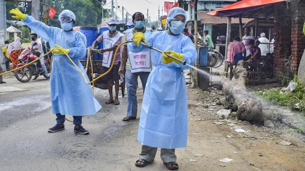 Members of a voluntary organization spray disinfectant in a market, in Nadia on September 28. “We changed the age group in the second survey from 18 years to 10 years and above because infection was also seen in younger population. Sero survey gives us virus exposure prevalence, but you may or may not have developed the disease,” Dr Balram Bhargava, director general, ICMR told a press briefing. (PTI)