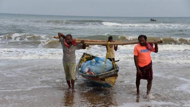 Fishermen pull their boat ashore in Puri earlier in June. Monsoon months extend from June to September.(PTI) Fishermen pull their boat ashore in Puri earlier in June. Monsoon months extend from June to September.(PTI)