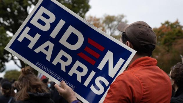 A demonstrator holds a “Biden Harris” placard outside the debate center at Case Western Reserve University in Cleveland, Ohio on September 29. Biden urged Americans to make a plan to vote and assured voters that Trump would be gone if Biden won. He said he would not declare victory until the outcome was validated, Reuters reported. (megan Jelinger / AFP)
