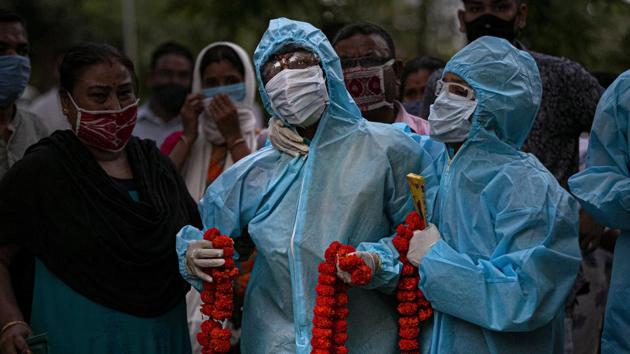 Relatives console a woman whose husband died of Covid-19 in Guwhati on September 28. Urban slum (15.6%) and non-slum (8.2%) areas had higher Sars-Cov2 infection prevalence than that of rural areas (4.4%), and prevalence in adults (above 18 years of age) was also higher at 7.1%, the findings show. (Anupam Nath / AP)