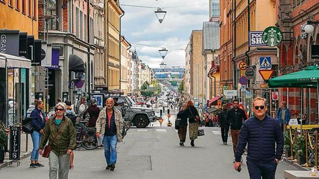 This picture taken in Stockholm, Sweden, on August 31, 2020, shows people walking in a street in Stockholm, amid the novel coronavirus pandemic.(Tom Little / AFP)