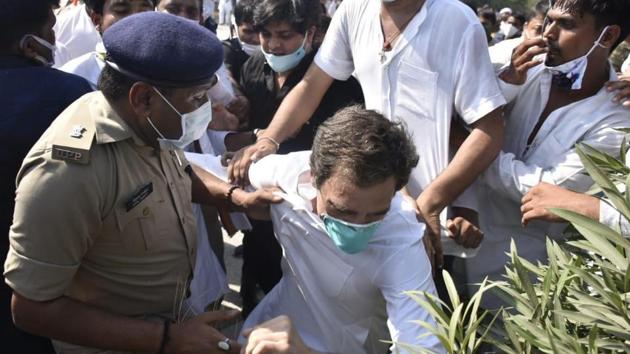 Rahul Gandhi seen taking a tumble even as a policeman tries to hold the leader by his kurta. (HT Photo)