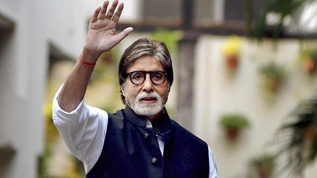 Bollywood actor Amitabh Bachchan waves to his fans at his residence in Mumbai.(PTI)