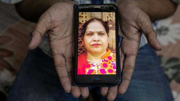 Fardeen Khan, 19, a student, shows a picture of his mother Noor Jahan, a housewife, who died of Covid-19, in New Delhi on September 27. “Since my mother died, my life has changed. There is no cure or vaccine for the disease and I wish there was one and my mother would have survived. I want people to follow precautions like social distancing until there is a cure for the disease,” Khan told Reuters. (Adnan Abidi / REUTERS)
