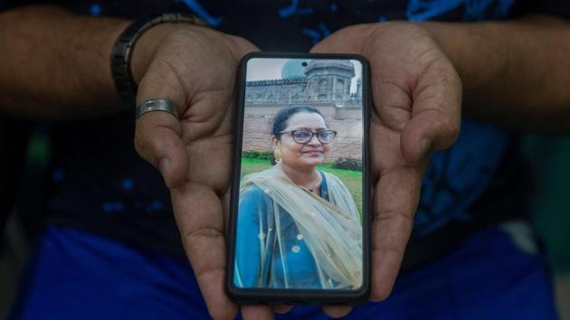 Nadeem Akhtar, a social worker, shows a picture of his sister Shabana Ahmed, an architect, who died of Covid-19, in New Delhi on September 24.”What really upsets me more than the health-care system was the behaviour of society,” Akhtar told Reuters. “My sister’s neighbourhood boycotted her family. There was no emotional or moral support even after her death. Society failed us.” (Danish Siddiqui / REUTERS)