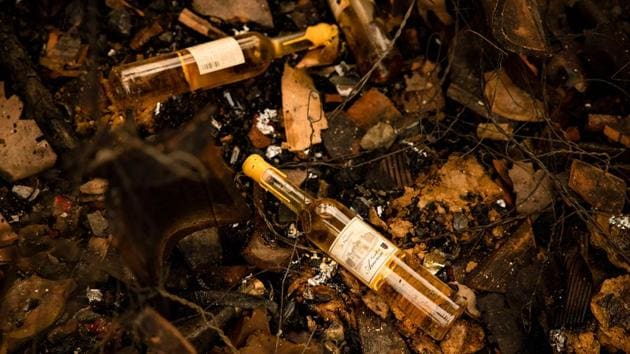 Charred bottles are seen in the remains of a warehouse at Castello di Amorosa winery in Napa Valley on September 29. According to the state officials, climate change induced droughts in California have catalysed the fire by creating ideal dry conditions for it to spread uncontrollably. (Samuel Corum / AFP)