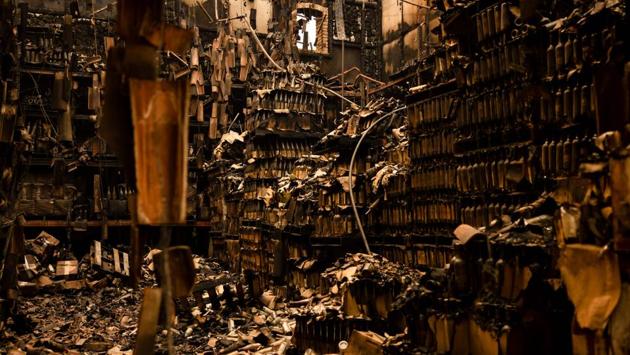 Charred bottles are seen in the remains of a warehouse at Castello di Amorosa winery in Napa Valley on September 29. (Samuel Corum / AFP)