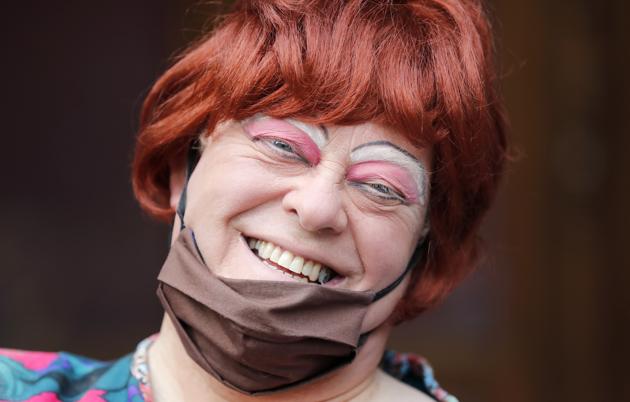 Actor Tim Hudson dressed as a pantomime dame poses for photographers as they march on Parliament to demand more support for the theatre sector amid the COVID-19 pandemic in London, Wednesday, Sept. 30, 2020. (AP)