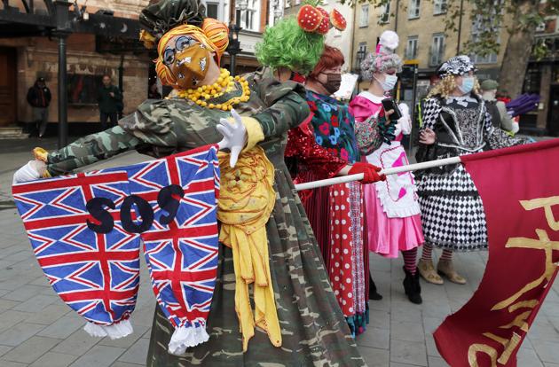 Actors dressed as a pantomime dames pose for photographers as they march on Parliament to demand more support for the theatre sector amid the COVID-19 pandemic in London, Wednesday, Sept. 30, 2020. (AP)