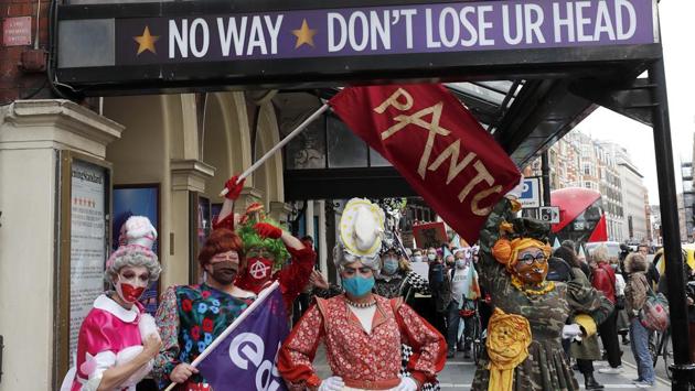 Actors dressed as pantomime dames pose for photographers as they march on Parliament to demand more support for the theatre sector amid the COVID-19 pandemic in London, Wednesday, Sept. 30, 2020. (AP)
