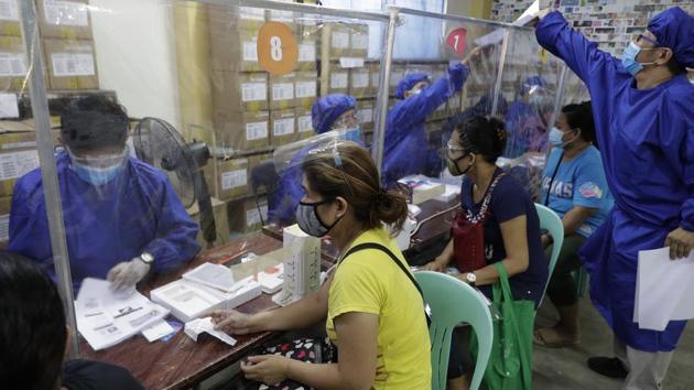 Teachers wearing protective suits to prevent the spread of the coronavirus, distribute student electronic tablets as they prepare for online classes at the opening of school next week at the Dona Rosario High School in Quezon city, Philippines, Thursday, Oct. 1, 2020. (AP) Teachers wearing protective suits to prevent the spread of the coronavirus, distribute student electronic tablets as they prepare for online classes at the opening of school next week at the Dona Rosario High School in Quezon city, Philippines, Thursday, Oct. 1, 2020. (AP)