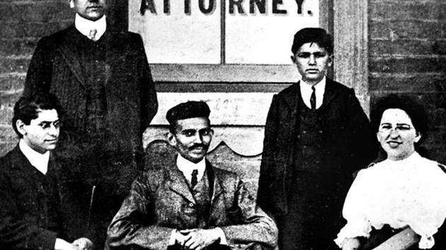 Mohandas Gandhi (center) sits with co-workers at his Johannesburg law office in 1902.(National Gandhi Museum)