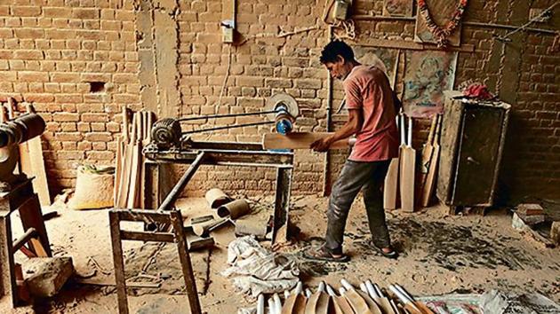 A worker gives finishing touches to a cricket bat at a factory on the outskirts of Jammu. (AP) A worker gives finishing touches to a cricket bat at a factory on the outskirts of Jammu. (AP)