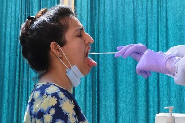 A health worker collects swab samples to test for Covid-19 at Lesiure Valley in Chandigarh’s Sector 10.(HT Photo)