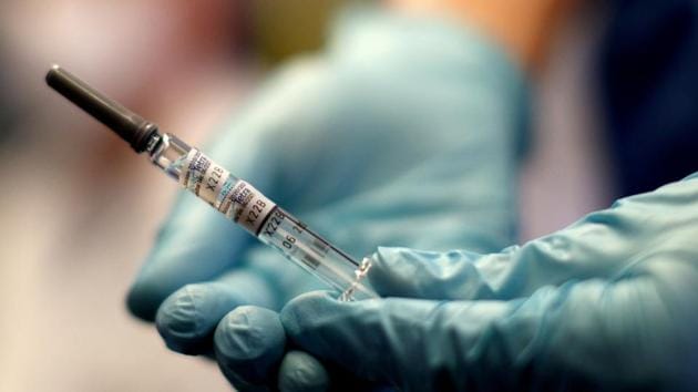 A healthcare worker of the free influenza vaccination programme holds a flu vaccine inside a tram, as the global spread of the the coronavirus disease (COVID-19) continues, in Vienna, Austria.(REUTERS)