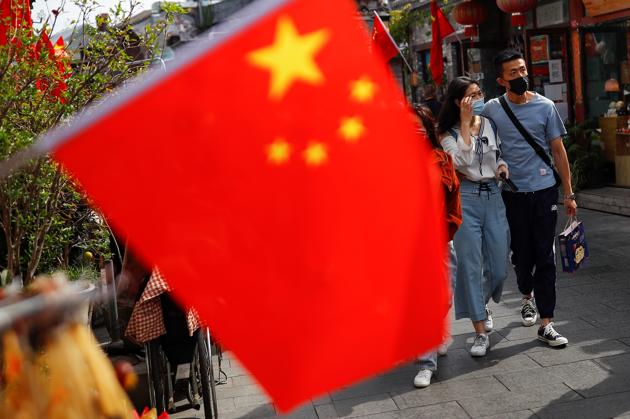 People walk in the tourist area surrounding Houhai Lake during Chinese National Day holidays in Beijing, China. (REUTERS) People walk in the tourist area surrounding Houhai Lake during Chinese National Day holidays in Beijing, China. (REUTERS)