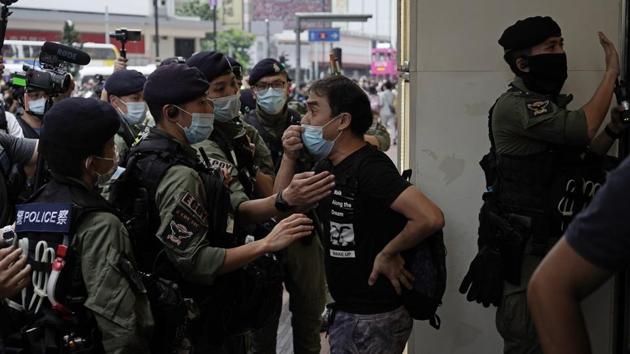 A man argues with riot police on China's National Day in Causeway Bay, Hong Kong (AP Photo/Kin Cheung)