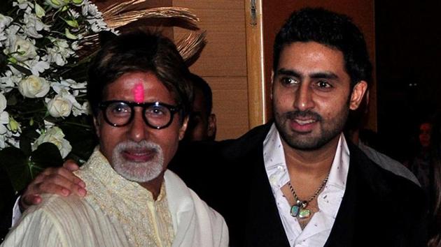 Bollywood actors Amitabh Bachchan (L) and his son Abhishek Bachchan pose for a picture during a party.(REUTERS)