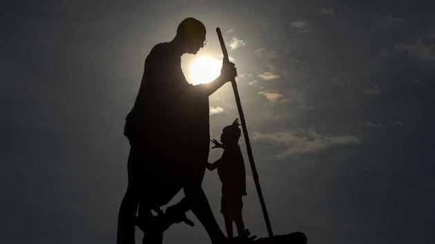 A worker cleans Mahatama Gandhi statue on the eve of his birth anniversary at Marina beach in Chennai on Thursday. (PTI Photo) A worker cleans Mahatama Gandhi statue on the eve of his birth anniversary at Marina beach in Chennai on Thursday. (PTI Photo)