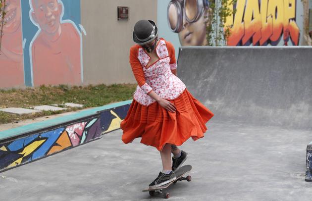 Yanira Villarreal, wearing a mask amid the COVID-19 pandemic and dressed as a "Cholita" rides a skateboard during a youth talent show in La Paz, Bolivia, Wednesday, Sept. 30, 2020. (AP)