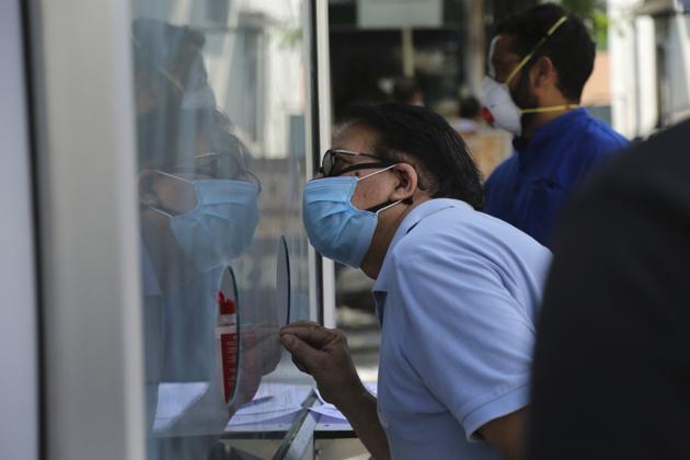 A man registers his name for Covid testing at a government hospital in Jammu on Thursday.(AP) A man registers his name for Covid testing at a government hospital in Jammu on Thursday.(AP)