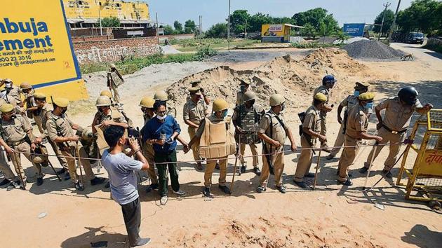 Policemen stand guard at the entrance to Hathras village in Uttar Pradesh on Friday.(HT Photos/Amal KS) Policemen stand guard at the entrance to Hathras village in Uttar Pradesh on Friday.(HT Photos/Amal KS)