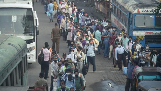 Office-goers wait to board buses in Thane on October 1. As of October 2, of the 6.47 million people infected in the country, 100,896 have lost their lives and over 5.42 million have recovered. The death toll is, however, expected to keep rising as the country is still adding 81,431 new cases a day on average. (Mitesh Bhuvad / PTI)