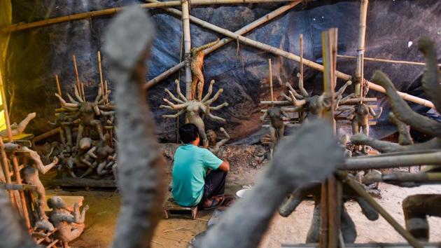 An artist works on a clay sculpture depicting Hindu goddess Durga ahead of Durga Puja, at CR Park, in New Delhi.(Amal KS/HT PHOTO)